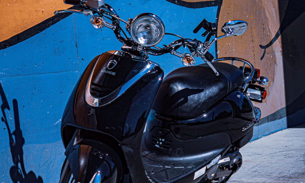 Side profile of Grey Triumph motorcycle in parking lot 