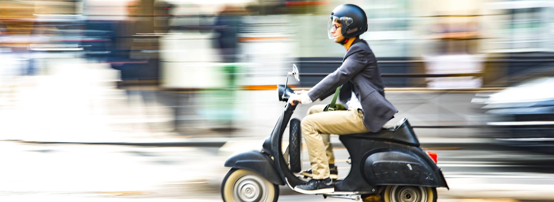 Motorcyclist riding green motorcycle on lake shore drive in Chicago, IL